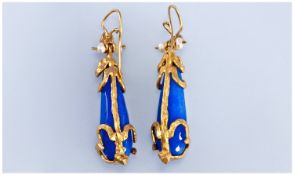 Pair Of Blue Faceted Lozenge Shaped Earrings, Set In A Yellow Metal Foliate Design Mount, Each With
