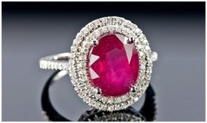 A 14k White Gold and DIamond Ring set with an oval cut ruby approx. 4.75ct. Diamonds approx total