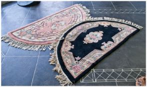 Two Demi Lune Woolen Rugs. One black, one pink, both with fringing. 51 x 27 inches.