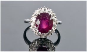 A Good Quality 14ct White Gold Set Ruby & Diamond Ring. The single stone ruby of approximately 6.