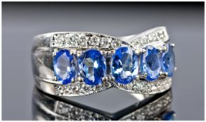 18ct White Gold Tanzanite And Diamond Dress Ring Set With A Central Row Of 5 Oval Tanzanite`s