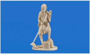 Japanese Ivory Carving Of A Farmer Toiling In The Field, with a rake in his hand and his foot on a