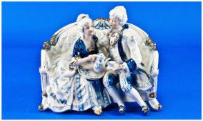 Staffordshire Figure Of A Couple In Regency Style Clothing Sat Drinking Tea.