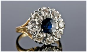 18ct Gold Set Diamond and Sapphire Ring Flower Head Design. The central sapphire surrounded by 8