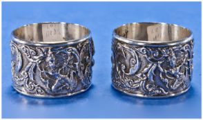 A Pair Of Heavy Quality Oriental Sterling Silver Napkin Rings, decorated with deities in relief to