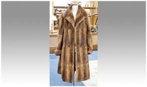 Golden Brown Musquash Full Length Coat, self lined collar, full sleeves narrowing in to a 4 inch