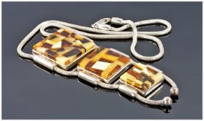 Large silver And Amber Pendant Comprising 4 Graduating Squares Of Reconstituted Amber Suspended On