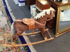 A Rocking Horse, with a cloth, wool body and leatherette saddle and harness, on wooden rocking