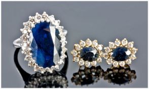 18ct White Gold Set Sapphire & Diamond Cluster Ring. The central single stone oval sapphire of dark