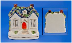 Staffordshire 19th Century Money Box in the form of a blue roof house with orange door. Encrusted