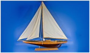 A Good Quality Large Handmade Wooden Model of a Sailing Yacht. With linen sails, raised on a wooden