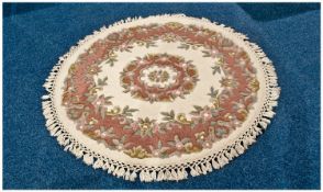 Modern Circular Wool Rug, pink floral decoration on cream ground with cream fringing. As new