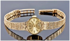 Ladies Exerite Manual Wind 9ct Gold Wrist Watch, fitted to a 9ct gold bark bracelet. Fully