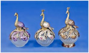 A 1950`s Set of a Matched Trio of Figural Topped and Overlaid Moulded Glass Perfume Bottles. The