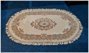 Modern Oval Wool Rug, floral decoration on beige ground. As new condition. 50 by 32 icnhes.