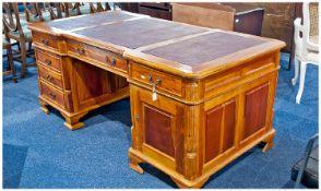 A 20th Century Light Wood Partners Desk. The top inset with leatherette panels above, one long draw