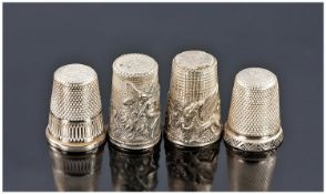 Four Silver Thimbles. One featuring an embossed fairy. The other an embossed dragon. Both marked