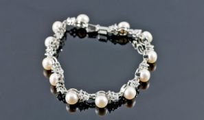 Cultured Freshwater White Pearl and Crystal Bracelet, an articulated row of the white button pearls