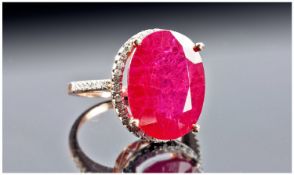 18ct Rose Gold Set Single Stone Ruby Ring. Flanked by small diamonds to rim and shoulders. The ruby