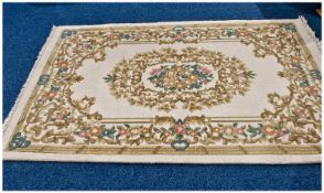 Rectangular Modern Wool Rug, pink floral background on beige ground with cream fringing. As new