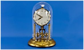 German-Kein Anniversary Clock with glass dome. Stands 11.25`` in height.