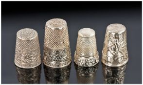 Four Silver Thimbles. Two with grape and vine borders. Unmarked but tests silver and probably