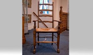 Early 20th Century Oak Ladder Back Arm Chairs with cane/rush seats. 2 in total. Tapered legs. Chair