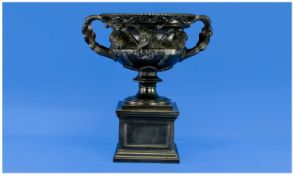 A 20th Century Two Handle Pedestal Bowl, with applied cherub decoration, raised on casket shaped