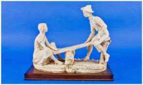 Signed Figure Group By A. Bernic Of A Loving Couple, on a see-saw. Decorated in a biscuit colour.