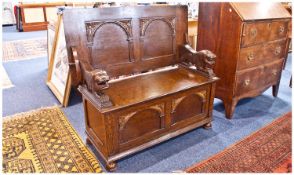 1930`s/1940`s Oak Monks Bench with lift up seat to the base, carved to the front with an arch