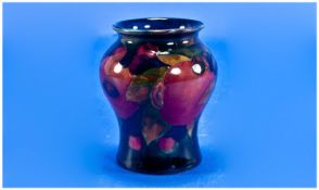 Moorcroft Small Vase ``Pomegranate and Berries`` Pattern on blue ground. c.1920`s. Height 3.25