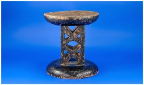 African Carved Wood Carrying Stool, the contoured seat top supported by two carved x frame side