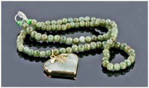 Chinese Green Jade Pendant Necklace, the heart shaped pendant bezel set and with an overlay of