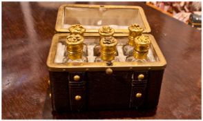 French Brown Leather Perfume Bottle Casket containing a set of six tapering glass phials with gilt