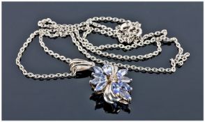 Tanzanite And Diamond Pendant, Of Floral Design Set In Silver, Suspended On a Fine Link Chain.