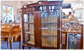 Edwardian Shaped Front Leaded Glass Display Cabinet. The bowed front has a pair of leaded glass