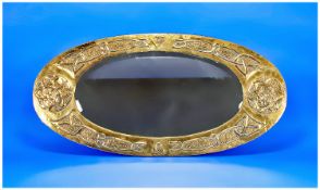 Glasgow School Type Brass Arts And Crafts Oval Wall Mirror. The embossed design to the frame is of