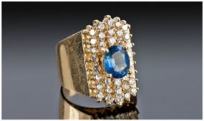 14ct Gold Sapphire And Diamond Cluster Ring Set With A Central Oval Cut Sapphire, Estimated Weight