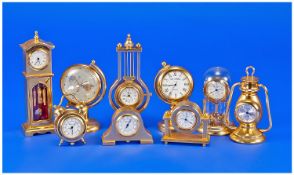 A Good Collection Of Gold Plated Miniature Clocks, in various forms and sizes, 9 in total. All