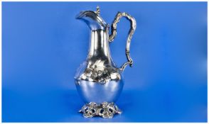 A 19th Century Silver Plated Water Jug with vacant cartouche and embossed decoration. Stands 11