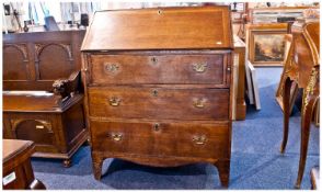 Late Victorian Oak Bureau, fall front with fitted sectioned interior on three long drawers bracket