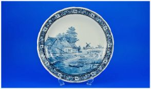 Delft Blue And White Charger Of Large Size, depicting a typical Dutch canal scene with windmills.