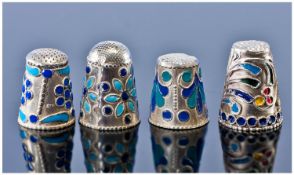 Four Attractive Silver And Enamel Thimbles. All decorated with stylized foliate shapes. One marked