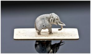 A Finely Detailed Miniature Silver Indian Elephant, standing four square on a rectangular bone