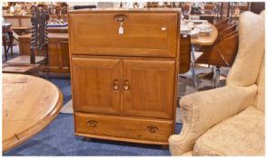 Ercol Writing Cabinet With Fall Down Front Flap. Fitted interior, cupboard below with one single