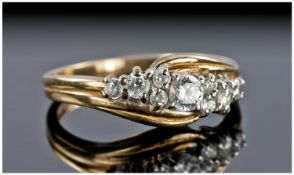 18ct Gold Set Diamond Ring. The central diamond flanked by 4 small diamonds to each side. Good