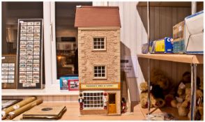 Large Dolls House Comprising Of Three Floors And An Attic. Toy shop on the ground floor and three