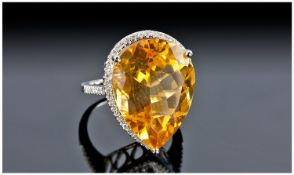 A 14ct White Gold And Diamond Ring. Set with a pear shaped yellow citrine of good colour,