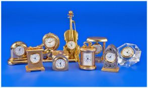 A Good Collection of Gold Plated Miniature Clocks, In Various Forms and Sizes. ( 9 ) In Total. All