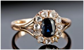 Sapphire And Diamond Cluster Ring Set With A Central Oval Sapphire Surrounded By Old Cut Diamonds,